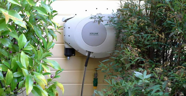 Hoselink Retractable Reel hanging on a clad wall